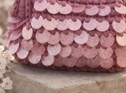 Paillettes rosa cucite a mano sull’intreccio della borsa Ortigia